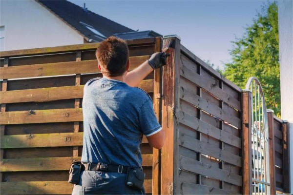 Handyman securing a damaged fence section restoring structural integrity with Fencing Invercargill Fence Repairs